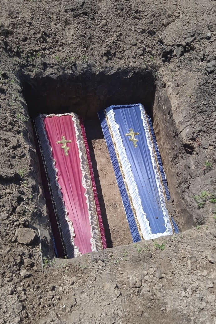 This photo provided by the family shows the coffins of two young cousins, Artem and Angelina Erashov, who were killed in Mariupol, Ukraine, during Russian shelling on March 9, 2022. Their parents fled Mariupol soon after but returned to the occupied city in July to rebury the children, ages 5 and 7, in the Staryi Krym cemetery, now the site of thousands of new graves since the Russian invasion began Feb. 24. (Family photo via AP)