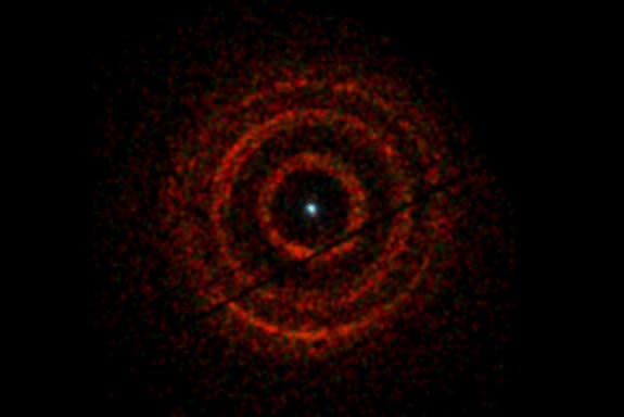 X-ray light released by an erupting black hole (dot at center) echoed off dust to form concentric rings around the binary system, V404 Cygni, which lies about 8,000 light-years from Earth.