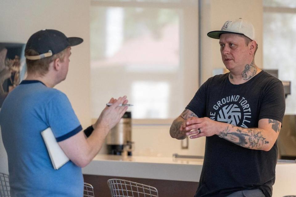 Chef Rick Mullins, right, goes over the presentation of dishes with friend Tyler Fox at the Kansas City Museum.