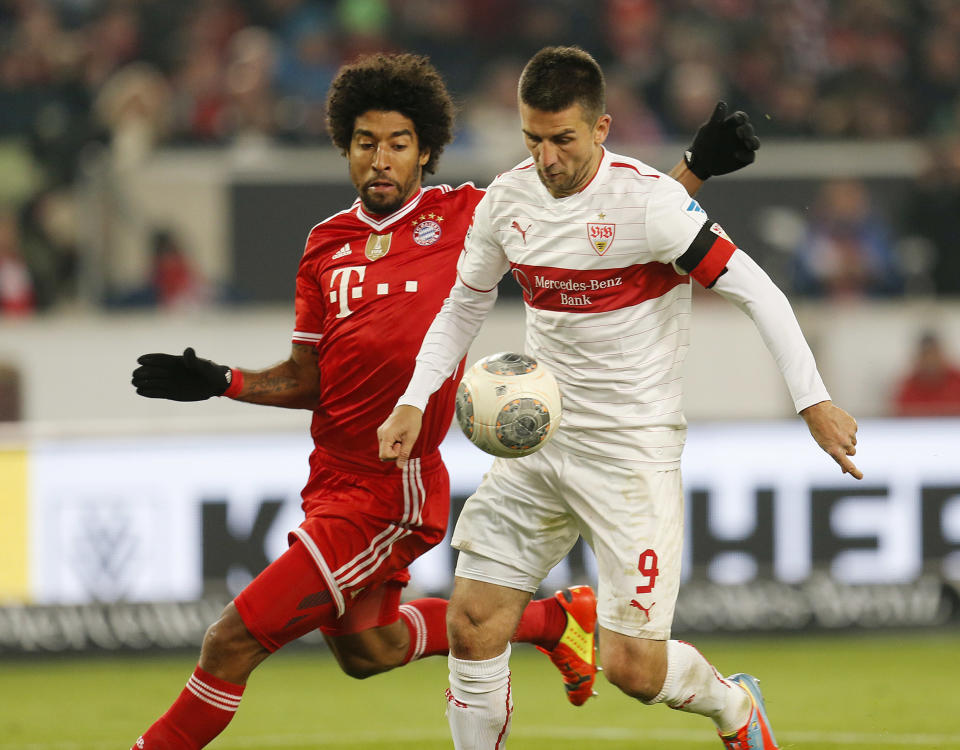 Stuttgart's Vedad Ibisevic of Bosnia, right, and Bayern's Dante of Brazil challenge for the ball during a German first soccer division Bundesliga match between VfB Stuttgart and FC Bayern Munich in Stuttgart, Germany, Wednesday, Jan. 29, 2014. (AP Photo/Michael Probst)