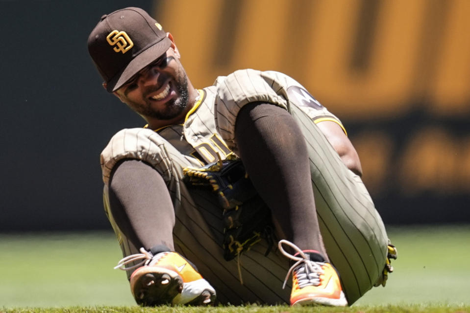 San Diego Padres second baseman Xander Bogaerts (2) kneels after injury fielding a ball hit by Atlanta Braves' Ronald Acuña Jr. in the third inning of a baseball game, Monday, May 20, 2024, in Atlanta. (AP Photo/Mike Stewart)