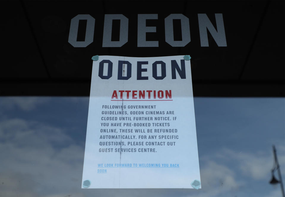 A sign in the door of an Odeon cinema in South Woodford, London, which has closed due to coronavirus. On Monday Prime Minister Boris Johnson called on people to stay away from pubs, clubs and theatres, work from home if possible and avoid all non-essential contacts and travel in order to reduce the impact of the coronavirus pandemic.