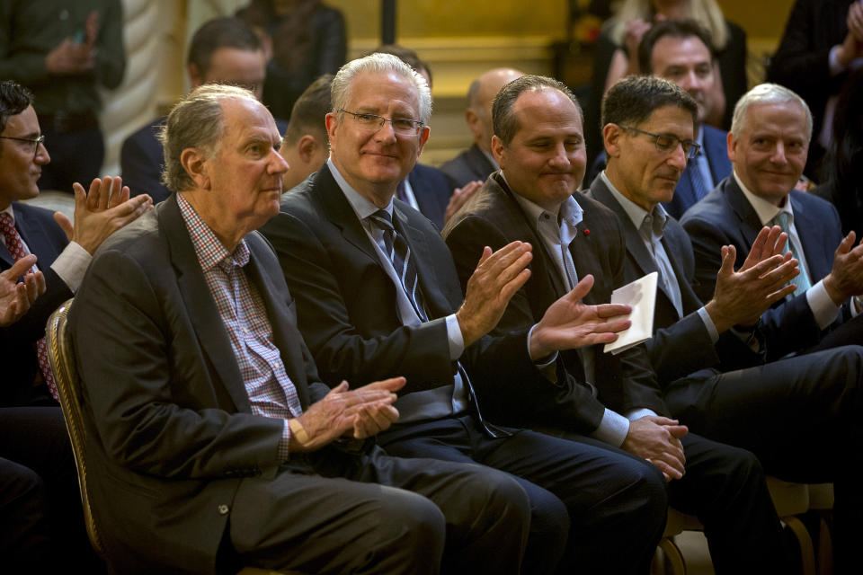 New Seattle hockey franchise majority owner David Bonderman, left, and Seattle Hockey Partners president and CEO Tod Leiweke, second left, react to the announcement by National Hockey League Commissioner Gary Bettman and the Board of Governors to name Seattle as the home of the league's 32nd franchise, Tuesday, Dec. 4, 2018, in Sea Island, Ga. . (AP Photo/Stephen B. Morton)