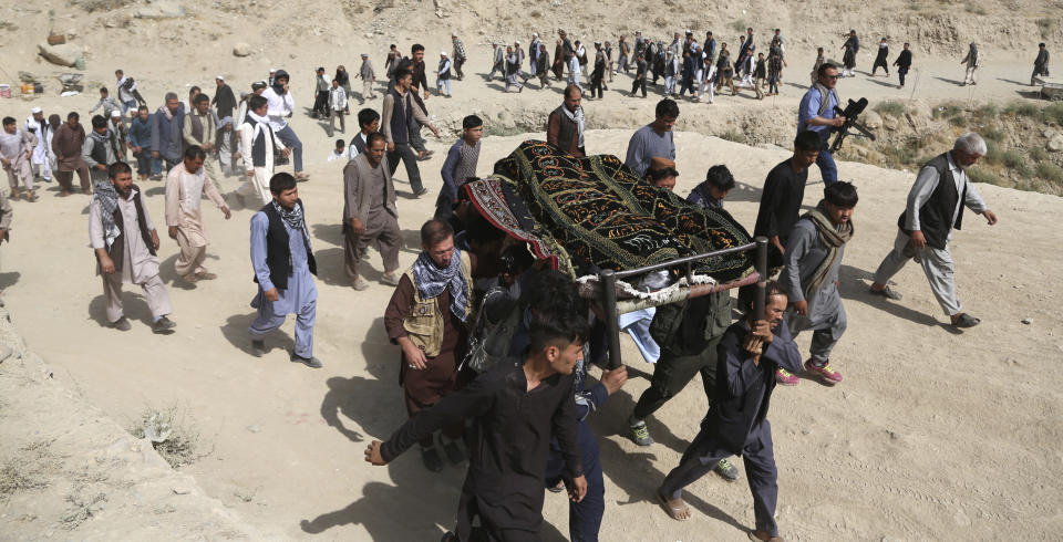 Men carry the coffin of a relative who died in Wednesday's deadly suicide bombing that targeted a training class in a private building in the Shiite neighborhood of Dasht-i Barcha, in western Kabul, Afghanistan, Thursday, Aug. 16, 2018. The Afghan authorities have revised the death toll from the previous day's horrific suicide bombing in a Shiite area of Kabul to 34 killed. (AP Photo/Rahmat Gul)