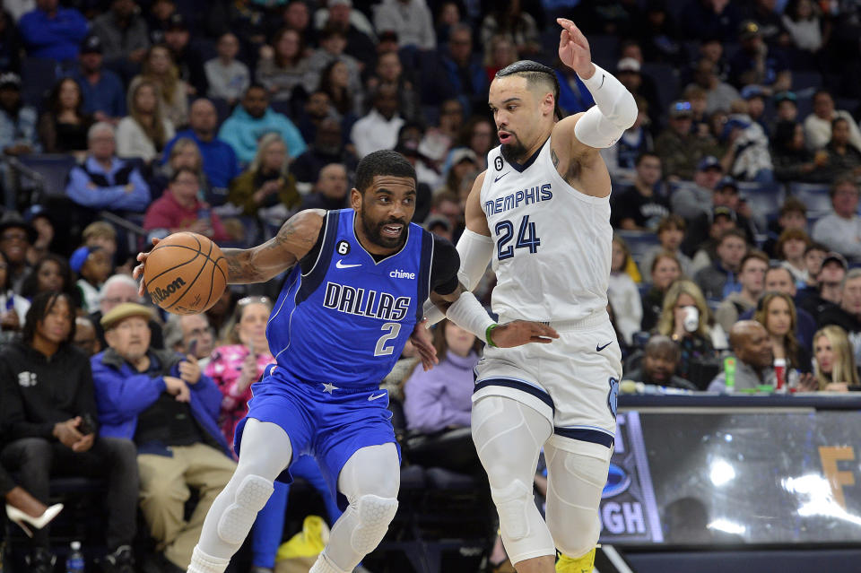 Dallas Mavericks guard Kyrie Irving (2) handles the ball against Memphis Grizzlies forward Dillon Brooks (24) in the first half of an NBA basketball game Monday, March 20, 2023, in Memphis, Tenn. (AP Photo/Brandon Dill)