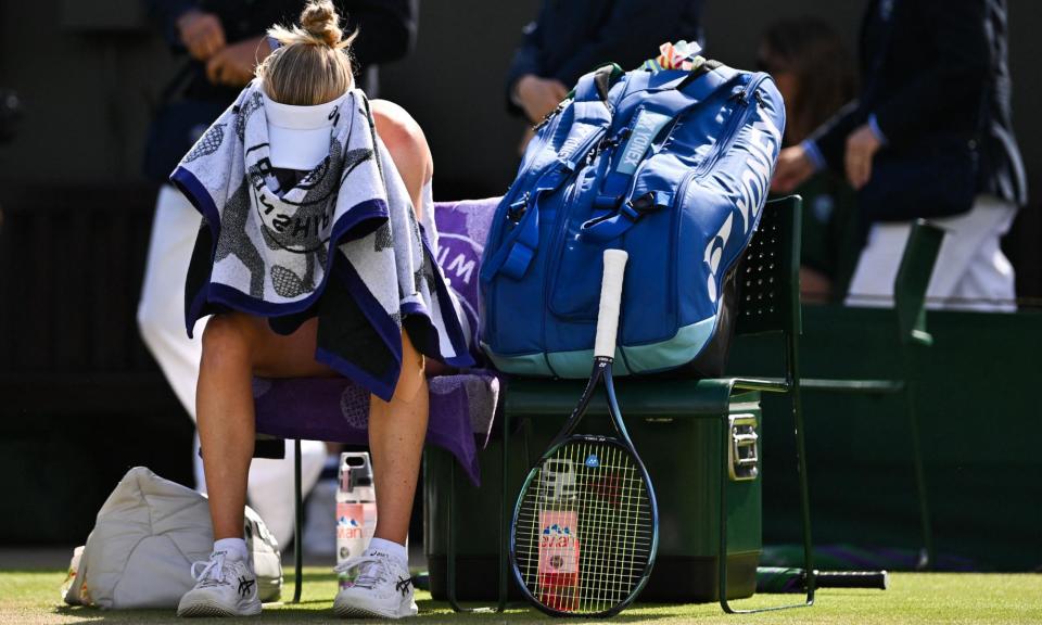 <span>Britain's Harriet Dart covers her face with a towel during a break against China's Wang Xinyu.</span><span>Photograph: Glyn Kirk/AFP/Getty Images</span>