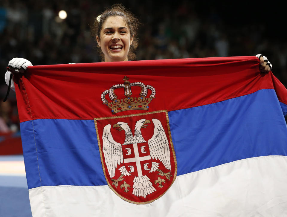 Serbia's Milica Mandic holds a Serbian national flag after defeating France's Anne-Caroline Graffe (not pictured) in their women's 67kg gold medal taekwondo final at the ExCel venue during the London 2012 Olympic Games August 11, 2012. REUTERS/Kim Kyung-Hoon (BRITAIN - Tags: OLYMPICS SPORT TAEKWONDO) 