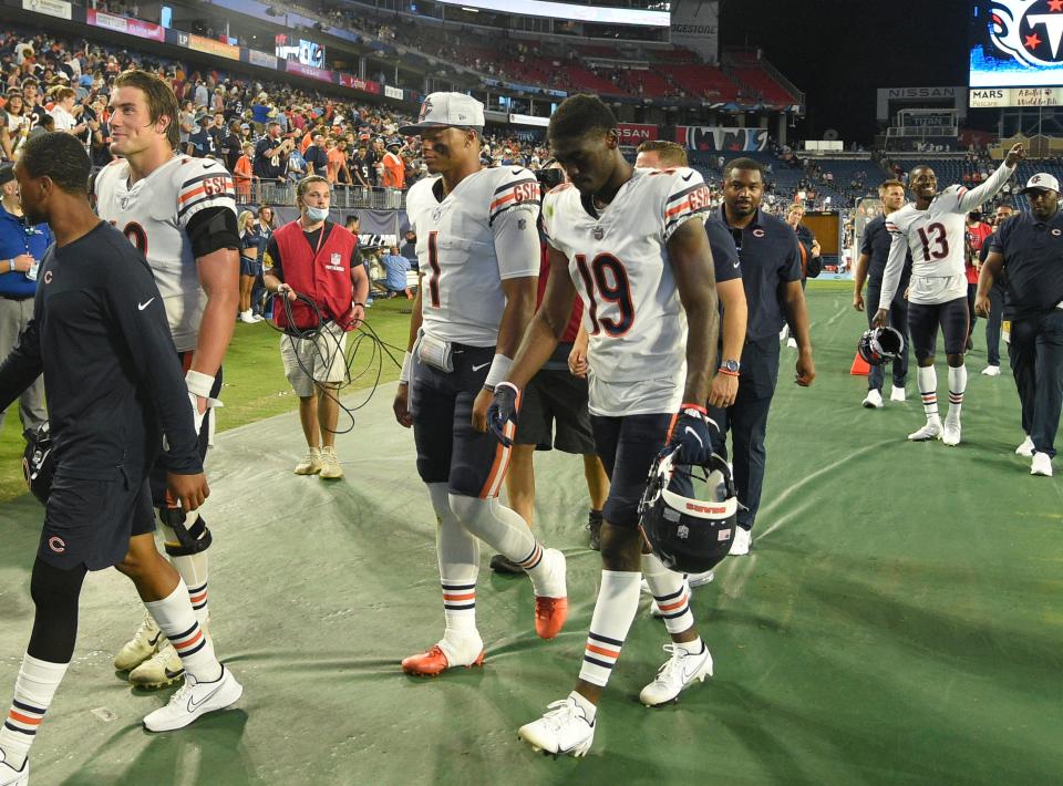 Bears wide receiver Isaiah Coulter, right, walks off the field with quarterback Justin Fields after a preseason game against the Titans in August 2021.