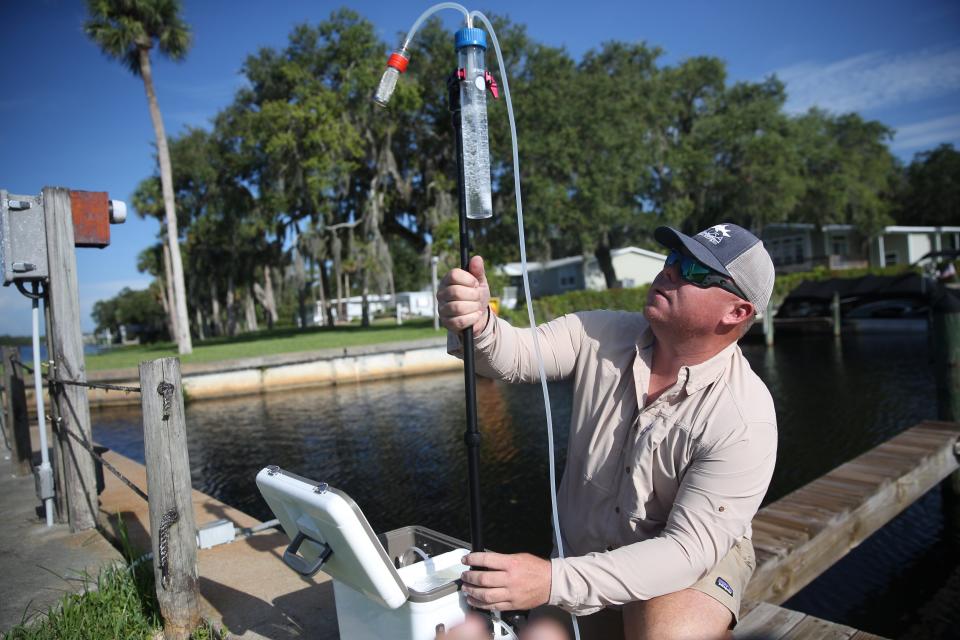 Codty Pierce, the Calusa Waterkeeper sets up an aerosol detection for algae monitoring unit along the Caloosahatchee River in Alva on Wednesday, July, 19, 2023. The unit will be deployed for 24 hours and will collect air samples which includes cyanotoxins. Pockets of the river and its tributaries are seeing blue green algae.