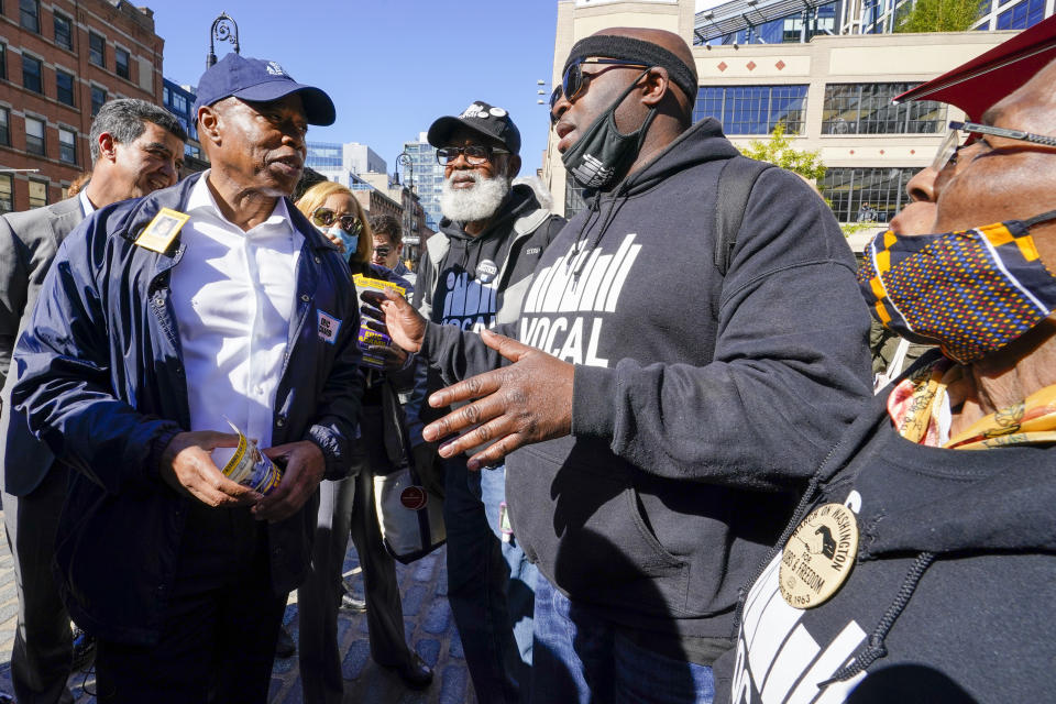 Democrat candidate for New York Mayor, Eric Adams, left, speaks to activists from VOCAL-NY during a campaign event, Tuesday, Oct. 19, 2021, in New York. (AP Photo/Mary Altaffer)