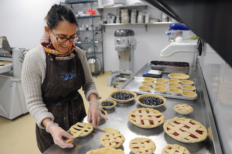 Dulce D Leche Pastry Chef Dayana Martim weaves a lattice top on a blueberry pie at the Ashland store, March 10, 2022.