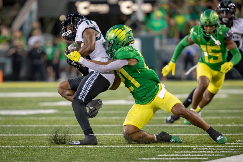 Oregon defensive back Cole Martin takes down Hawaii running back Jordan Johnson as the Oregon Ducks host Hawaii Saturday, Sept. 16, 2023, at Hayward Field in Eugene, Ore.