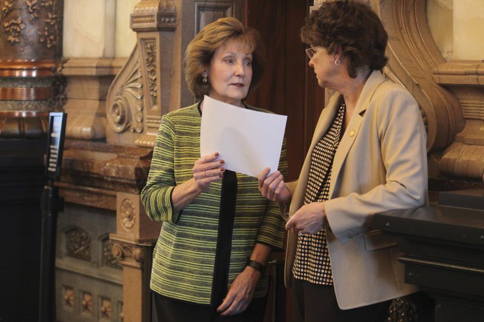 Kansas state Sens. Brenda Dietrich, left, R-Topeka, and Carolyn McGinn, right, R-Sedgwick, confer before a vote on a proposed ban on gender-affirming care for minors, Wednesday, March 27, 2024, at the Statehouse in Topeka, Kan. McGinn opposes the proposal, but Dietrich's backing of it after she opposed a ban in 2023 gave the measure a two-thirds majority supporters would need to override an expected veto from Democratic Gov. Laura Kelly. (AP Photo/John Hanna)