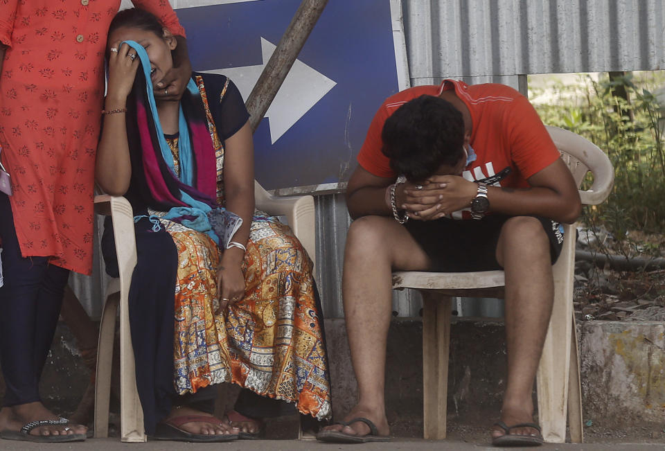 Relatives of a person who died of COVID-19 mourn outside a field hospital in Mumbai, India, Monday, May 3, 2021. (AP Photo/Rafiq Maqbool)