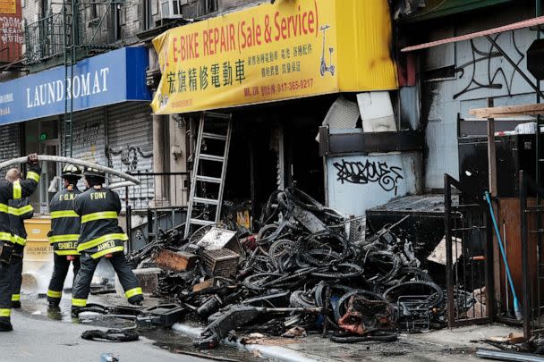 PHOTO: Firefighters work outside a building in Chinatown after four people were killed by a fire in an e-bike repair shop overnight, June 20, 2023 in New York City. (Spencer Platt/Getty Images)