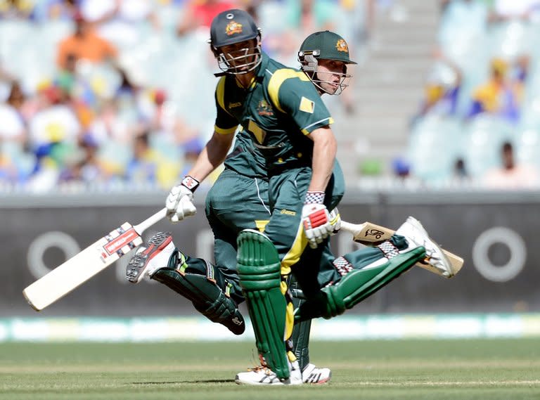 Australia batsman Phillip Hughes (R) and captain George Bailey (L) run between the wickets during the first one-day international against Sri Lanka on January 11, 2013. Hughes was the only member of the Test XI who played in Adelaide, in the second one-day international