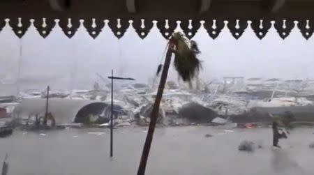 General view of half-submerged vehicles, boats and debris in the flooded harbour as Hurricane Irma hits the French island territory of Saint Martin September 6, 2017, in this video grab made from footage taken from social media. Mandatory credit RCI GUADELOUPE/Handout via REUTERS