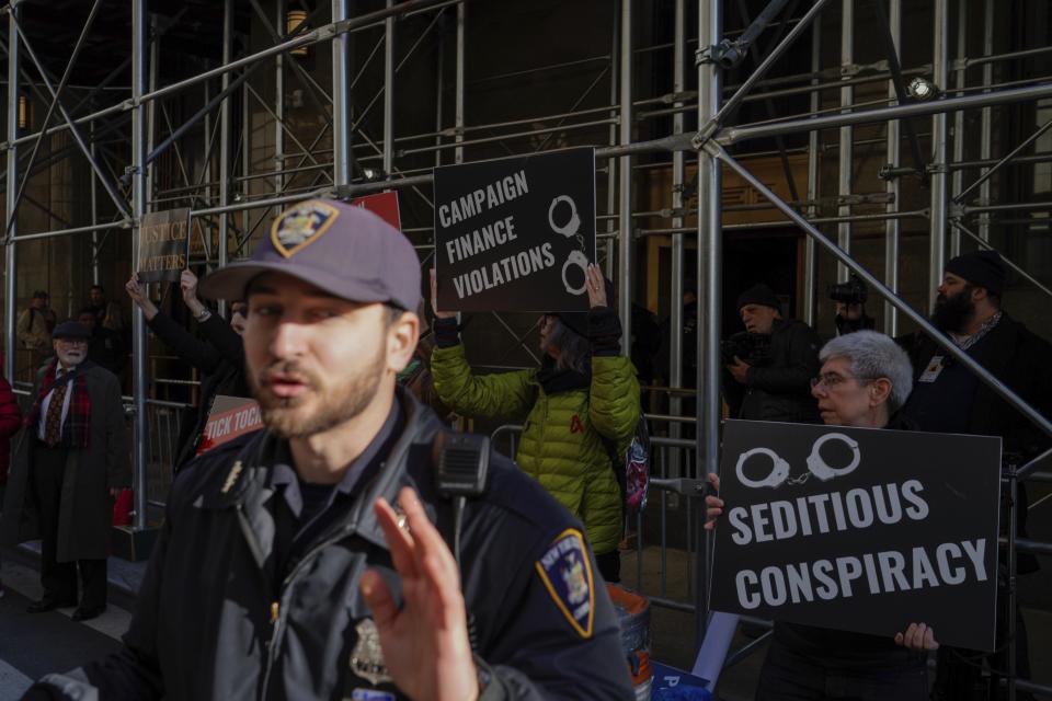 People protest in front of the District Attorney office ahead of former President Donald Trump's anticipated indictment on Tuesday, March 21, 2023, in New York. A New York grand jury investigating Trump over a hush money payment to a porn star appears poised to complete its work soon as law enforcement officials make preparations for possible unrest in the event of an indictment.(AP Photo/Eduardo Munoz Alvarez)