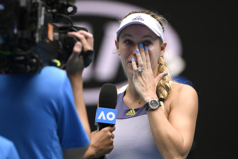 Denmark's Caroline Wozniacki wipes away tears after a third round loss to Tunisia's Ons Jabeur at the Australian Open tennis championship in Melbourne, Australia, Friday, Jan. 24, 2020. (AP Photo/Andy Brownbill)