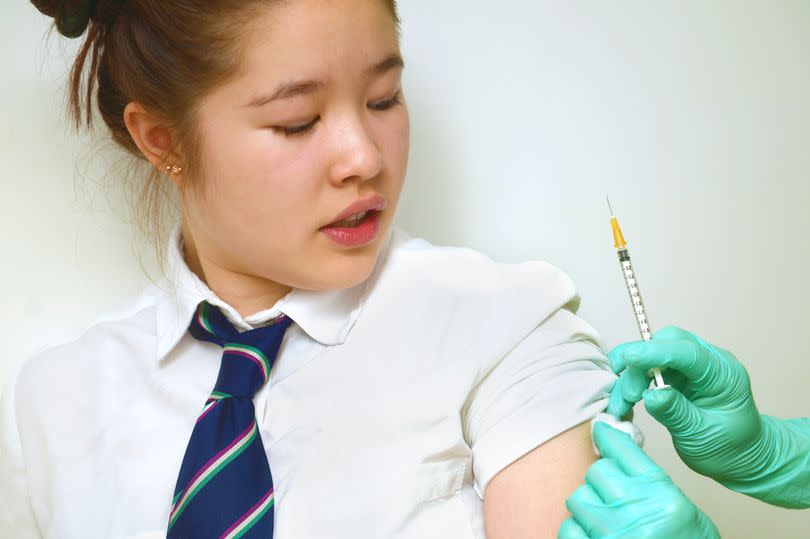 Close up of a schoolgirl having an injection