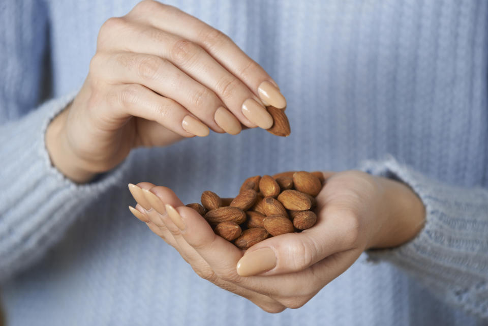 hand holding almonds