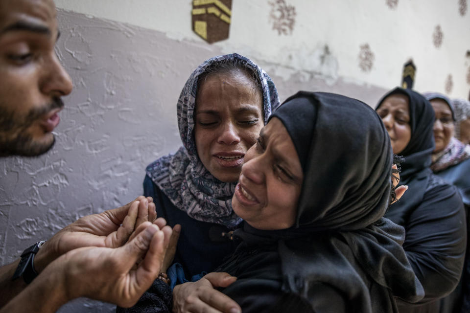 Relatives mourn the death of Palestinian Hamas militant, Mohammad Abu Namous, 27, in the family home during his funeral in the Jabaliya refugee camp, northern Gaza Strip, Sunday, Aug. 18, 2019. Gaza's Health Ministry said Israeli troops killed three Palestinians and severely wounded a fourth near the heavily guarded perimeter fence. The Israeli military said Sunday that a helicopter and a tank fired at a group of armed suspects near the fence overnight. (AP Photo/Khalil Hamra)