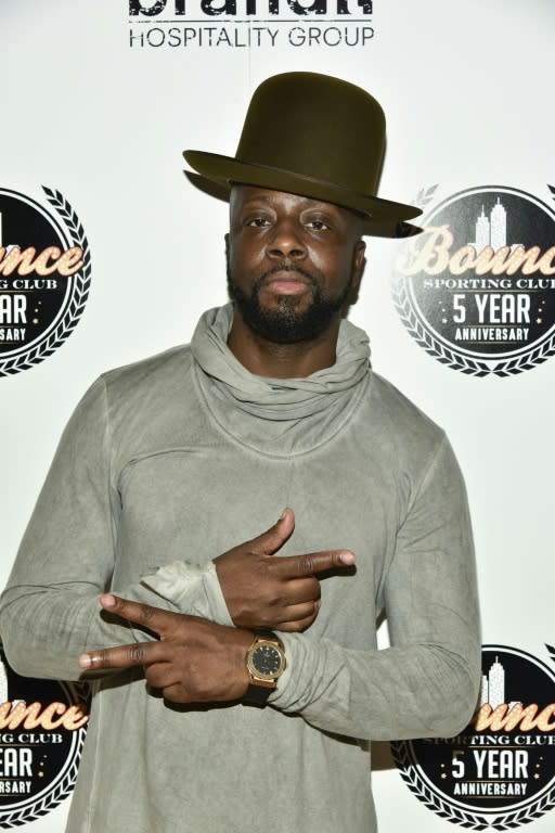 Singer Wyclef Jean appeared in music videos with the wife of the head of a wealthy Singaporean Christian church, who had his jail term slashed on appeal Friday for misusing over $35 million in congregation funds to promote his wife's music career