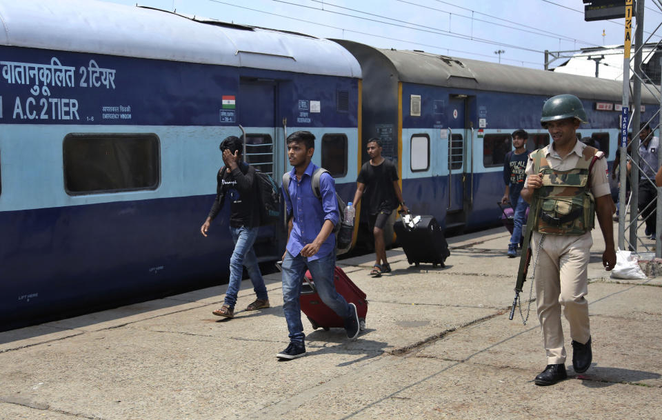 National Institute of Technology (NIT) students who left Srinagar, Kashmir's main city arrive to board a train to leave for their respective homes from a railway station in Jammu, India, Sunday, Aug. 4, 2019. Thousands of Indian students and visitors were fleeing Indian-controlled Kashmir over the weekend after the government ordered tourists and Hindu pilgrims visiting a Himalayan cave shrine "to curtail their stay" in the disputed territory, citing security concerns. (AP Photo/Channi Anand)