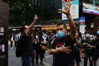 Pro-democracy protesters gesture while urging release of twelve Hong Kong activists