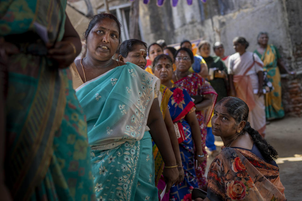 Women wait to cast their votes during the first round of polling of India's national election in Chennai, southern Tamil Nadu state, Friday, April 19, 2024. Nearly 970 million voters will elect 543 members for the lower house of Parliament for five years, during staggered elections that will run until June 1. (AP Photo/Altaf Qadri)