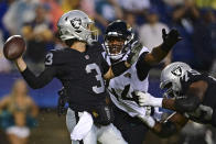 Las Vegas Raiders quarterback Jarrett Stidham (3) throws a pass under pressure from Jacksonville Jaguars linebacker Travon Walker (44) during the first half of the NFL football Hall of Fame Game exhibition Thursday, Aug. 4, 2022, in Canton, Ohio. (AP Photo/David Dermer)