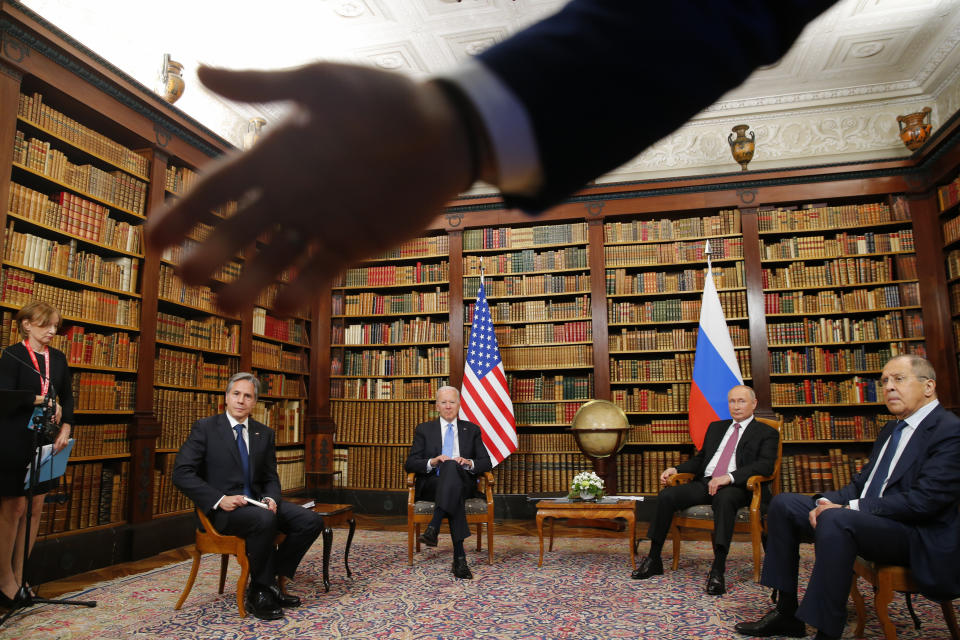 A security officer indicates to the media to step back as U.S. President Joe Biden, second from left, U.S. Secretary of State Antony Blinken, left, Russia's President Vladimir Putin, second from right, and Russia's Foreign Minister Sergei Lavrov, right, meet for the U.S.-Russia summit at Villa La Grange in Geneva, Switzerland, Wednesday, June 16, 2021. (Denis Balibouse/Pool Photo via AP)