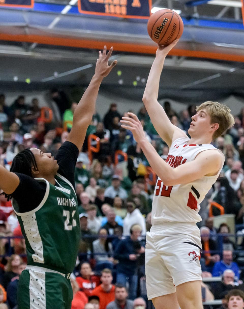 Metamora's Cooper Koch shoots over Richwoods' Lathan Sommerville in the second half of their Class 3A boys basketball sectional title game Friday, March 1, 2024 at Pontiac High School. The Knights upset the defending champion Redbirds 61-55.