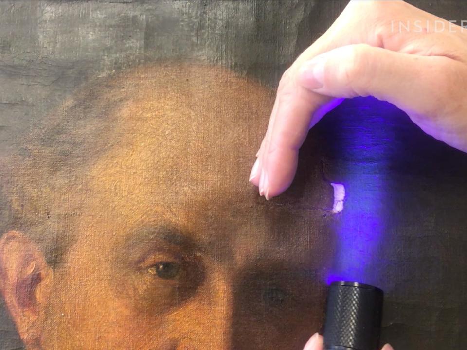 A black light used on a painting to reveal imperfections.