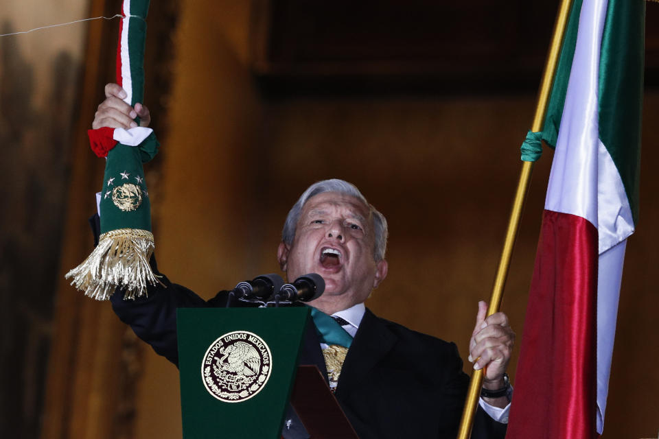 FILE - Mexican President Andres Manuel Lopez Obrador rings the bell as he gives the annual independence shout from the balcony of the National Palace to kick off subdued Independence Day celebrations amid the ongoing coronavirus pandemic, at the Zocalo in Mexico City, Sept. 15, 2020. With Morena now dominant in Mexico, the biggest question in politics has become what kind of internal divisions will hit the party basically built around López Obrador, when he retires in 2024. (AP Photo/Rebecca Blackwell, File)