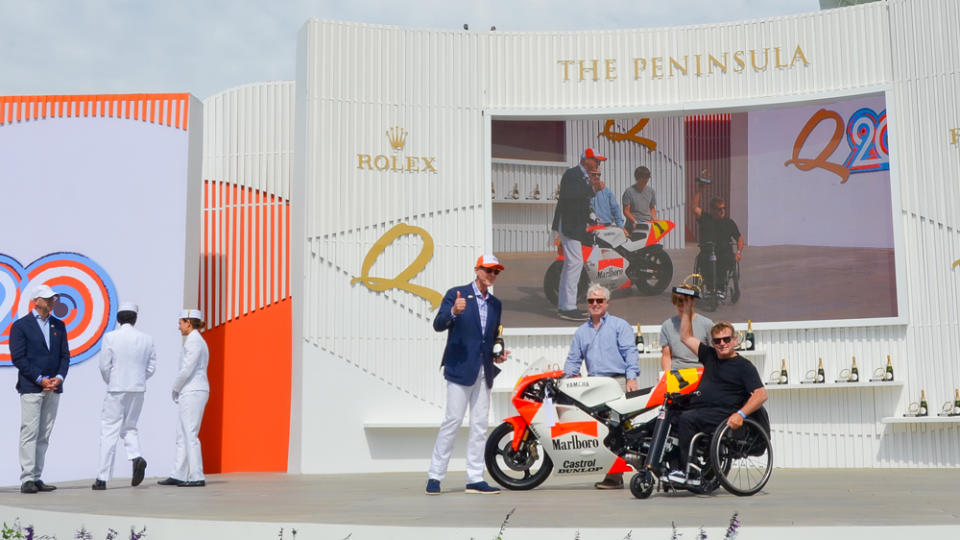 Wayne Rainey hoists the Best in Class trophy for the Sports and Racing Motorcycles category at the Quail, a Motorsports Gathering 2023.