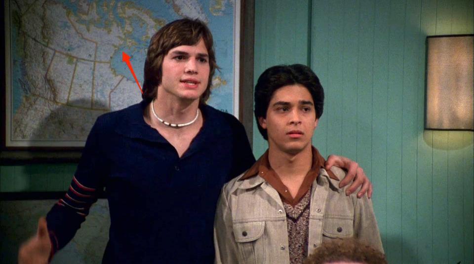 A red arrow pointing to a map of Canada behind Kelso and Fez on season three of "That '70s Show."