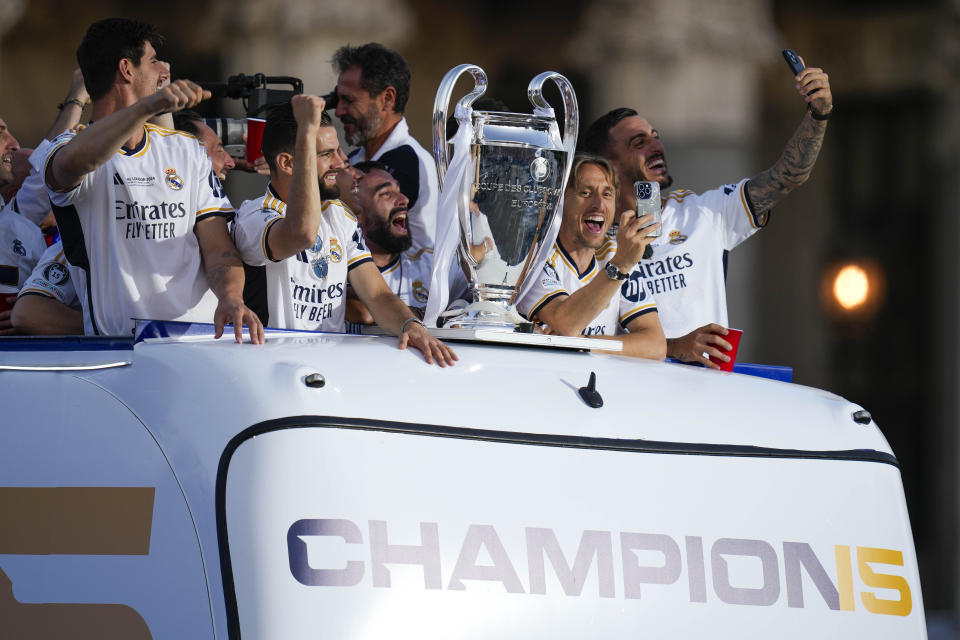 Real Madrid players celebrate during the Champions League trophy parade at the Cibeles square in Madrid, Spain, Sunday, June 2, 2024. Real Madrid won against Borussia Dortmund 2-0. (AP Photo/Bernat Armangue)
