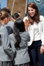 <p>Kate shares a high-five with school girls as she arrives at the 1851 Trust roadshow at the Docklands Sailing and Watersports Centre.</p>