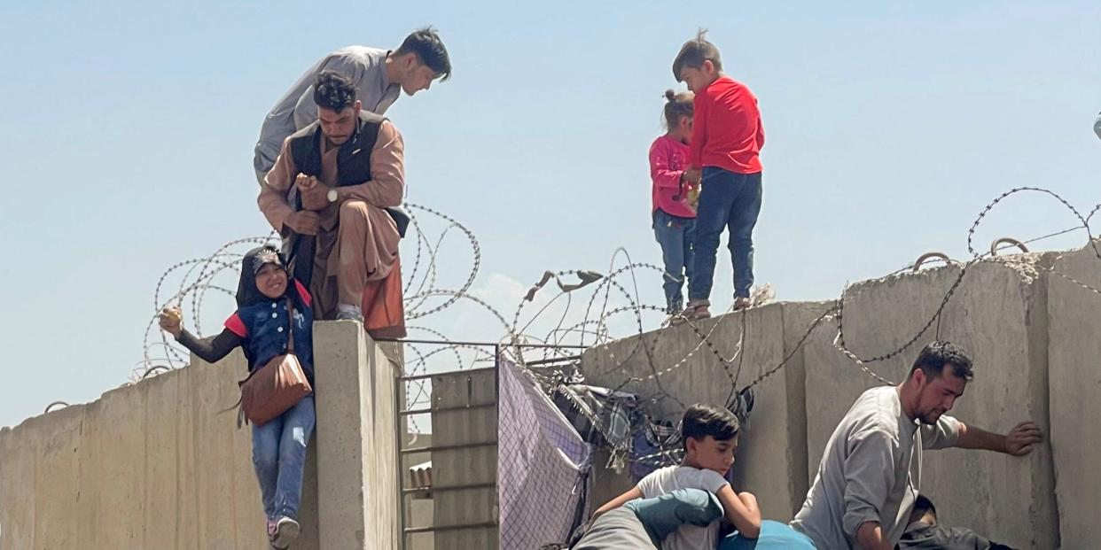 A man pulls a girl to get inside Hamid Karzai International Airport in Kabul, Afghanistan August 16, 2021