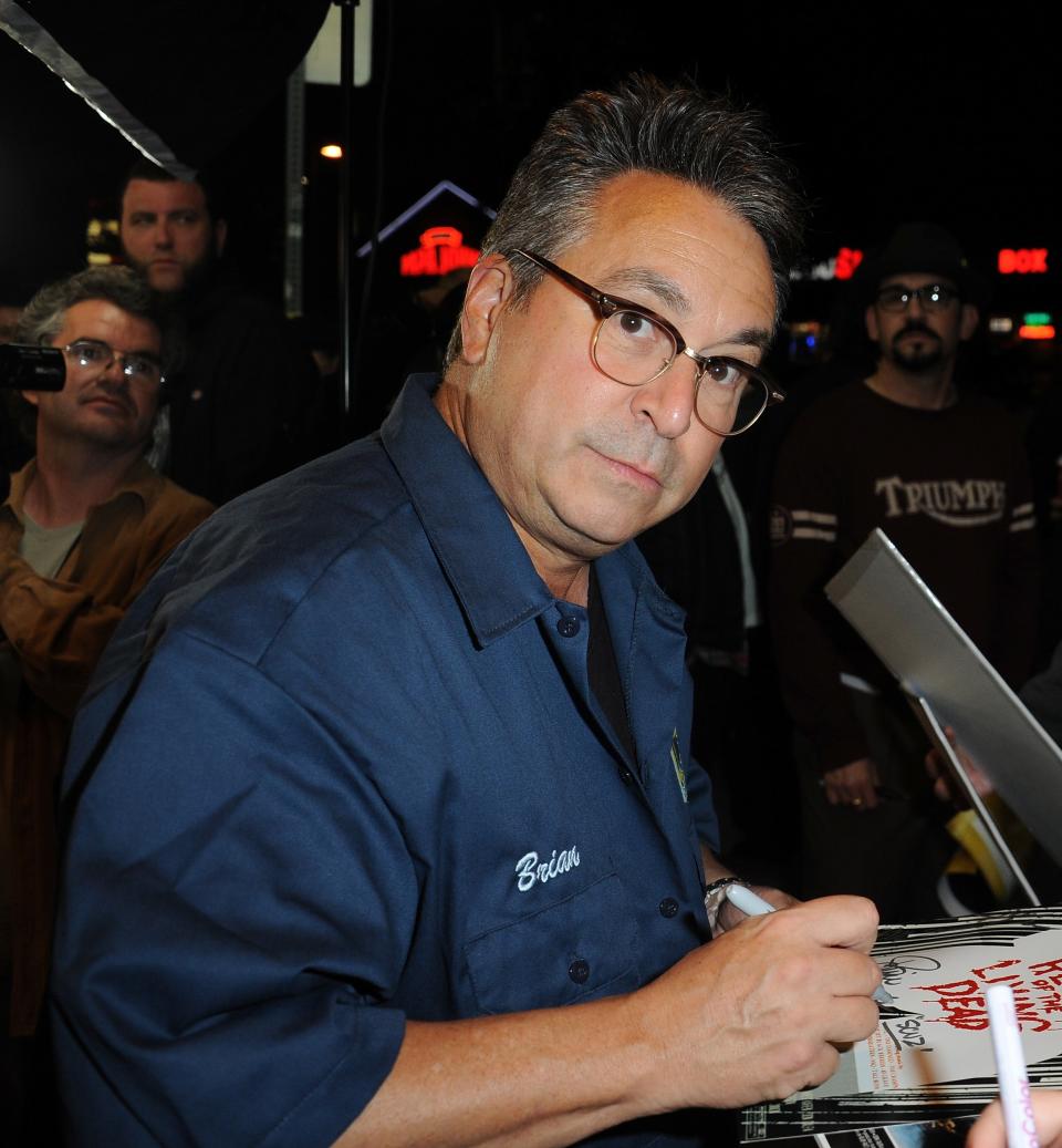 A closeup of Brian Peck signing autographs