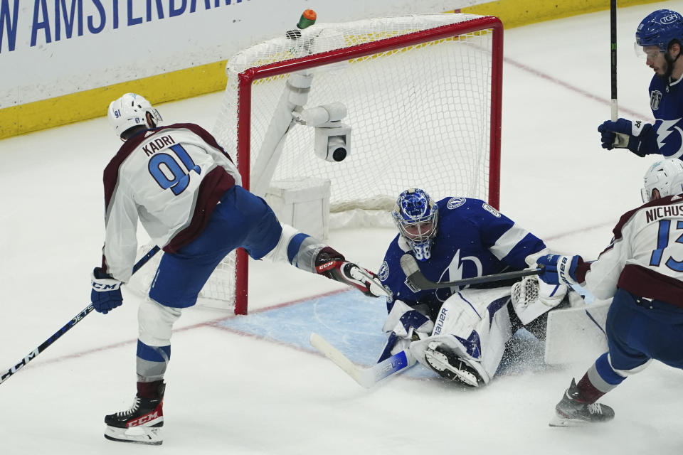 Colorado Avalanche center Nazem Kadri shoots the puck into the top of the goal past Tampa Bay Lightning goaltender Andrei Vasilevskiy (88) for a goal during overtime of Game 4 of the NHL hockey Stanley Cup Finals on Wednesday, June 22, 2022, in Tampa, Fla. (AP Photo/John Bazemore)