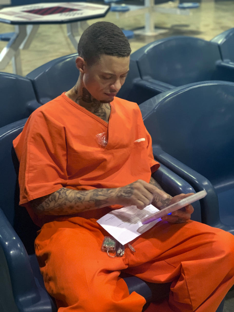 In a photo provided by the North Fork Correctional Center in Sayre, Okla., on Tuesday, June 9, 2021, inmate Byron Robinson works on a new Securus tablet, which are being provided for free to Oklahoma inmates as part of a new program by the Department of Corrections. Robinson, who has been incarcerated since 2005, the same year YouTube was founded, said it was the first time he'd ever held a computer tablet. The devices will include free content like access to a law library, along with some podcasts, books and educational materials. (Lance West/Oklahoma Department of Corrections via AP)