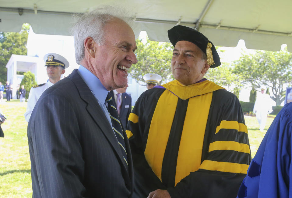 Secretary of the Navy Richard Spencer, left, laughs while waiting with Acting President of the U.S. Naval War College Dr. Lewis Duncan, right, prior to the U.S. Naval War College's commencement ceremony, Friday, June 14, 2019, in Newport, R.I. (AP Photo/Stew Milne)
