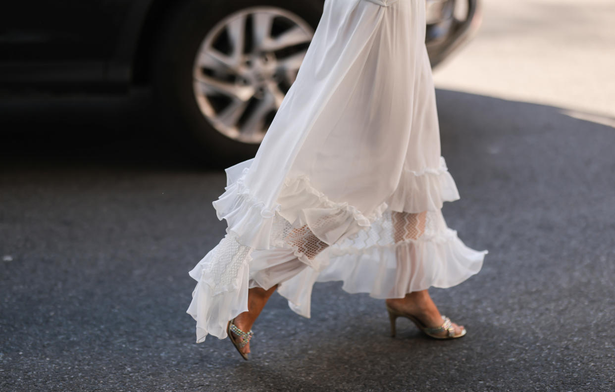 bridal white dress, woman wearing white ruffle dress and gold sandal, white wedding engagement party dress