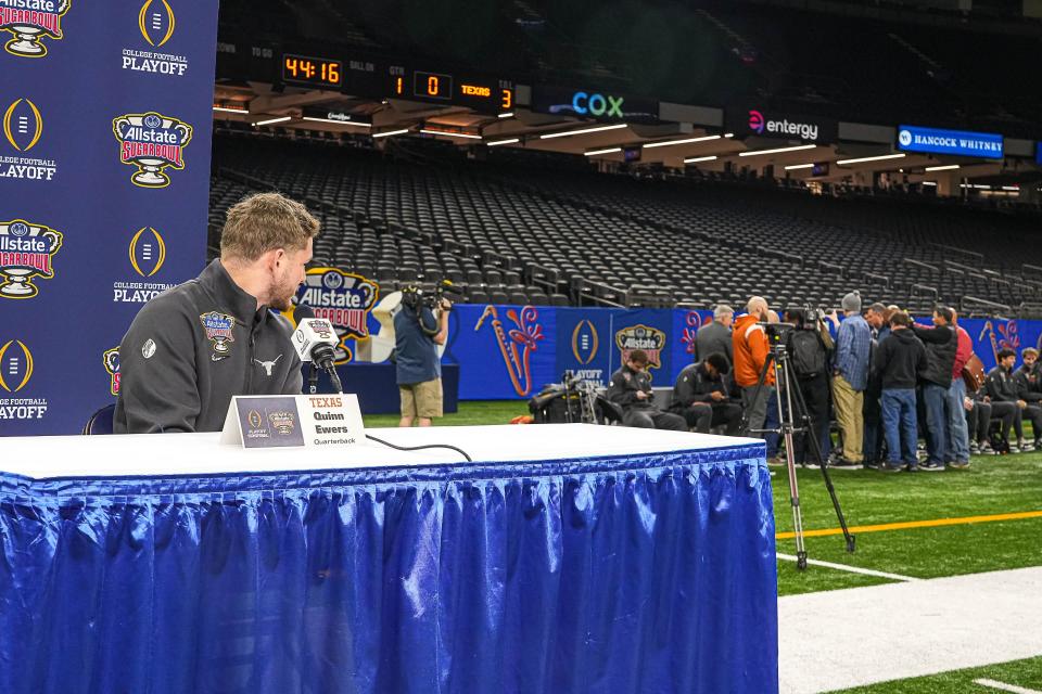 Texas Longhorns quarterback Quinn Ewers (3) looks at a press scrum around quarterback Arch Manning during Texas Media Day at the Superdome on Saturday, Dec. 30, 2023 in New Orleans, Louisiana. The Texas Longhorns will take on the Washington Huskies in the College Football Playoff Semi-Finals on January 1, 2024.