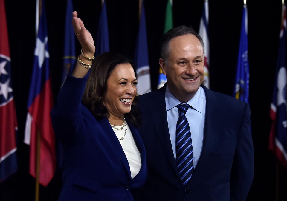 Democratic vice presidential running mate Kamala Harris and her husband Douglas Emhoff pose on stage after the first Biden-Harris press conference in Wilmington, Delaware, on August 12, 2020.