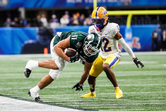 Michigan State tight end Connor Heyward runs Pittsburgh defensive back M.J. Devonshire during the second half of the 31-21 win over Pittsburgh in the Peach Bowl at the Mercedes-Benz Stadium in Atlanta on Thursday, Dec. 30, 2021.