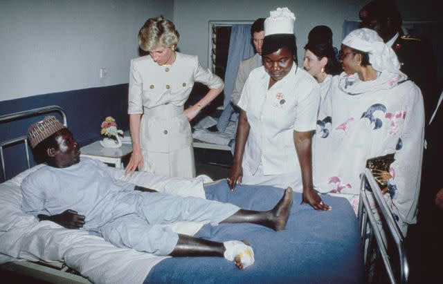 <p>Tim Graham Photo Library via Getty</p> Princess Diana at a leprosy hospital and rehabilitation village in Maiduguri, Nigeria on March 17, 1990.