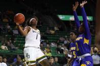 Baylor forward NaLyssa Smith (1) makes a pass around the defense of Morehead State's Julan McDonald (35) and Jada Claude (2) in the second half of an NCAA college basketball game in Waco, Texas, Tuesday, Nov. 30, 2021. (AP Photo/Tony Gutierrez)